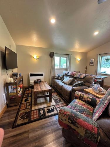 a living room with a couch and a table at Glacier Homestead in Coram