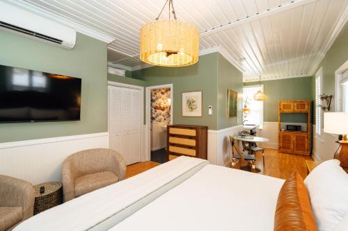 a bedroom with a bed and chairs in a room at Swank Boutique Suites in Ashland