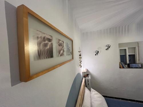 a picture hanging on a wall in a room at Casa Berri in Vejer de la Frontera