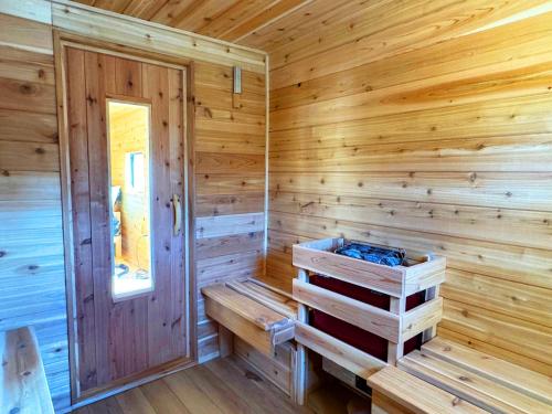 a wooden cabin with a sauna with a door at Family Lake House Waterfront in Saugerties