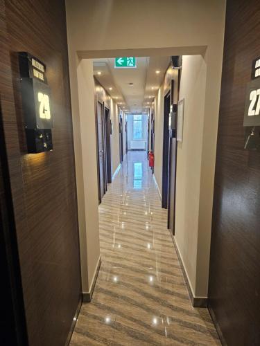 a hallway in a building with a sign on the wall at Hotel City Faber in Worms