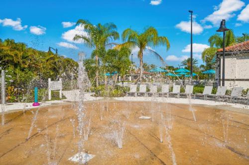 a fountain in a park with palm trees at Epic Universe Lake View Condo, Vista Cay - 1005 in Orlando