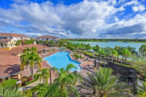 an aerial view of a pool at a resort with a lake at Epic Universe Lake View Condo, Vista Cay - 1005 in Orlando