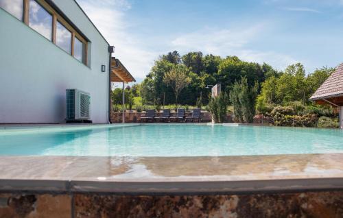 a swimming pool in the backyard of a house at Ferienhaus Mit Pool in Ehrenhausen