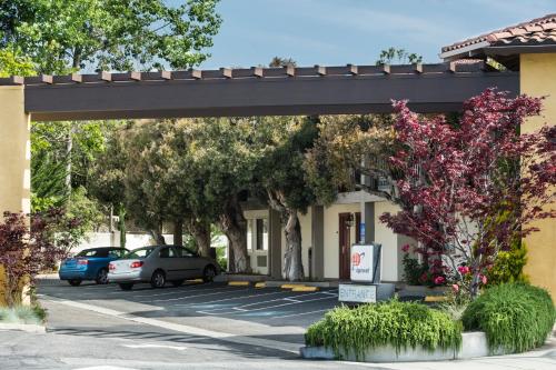 a parking lot with cars parked in front of a building at Mission Inn in Santa Cruz