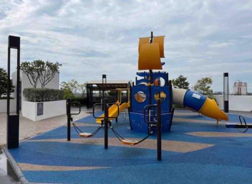 a playground with a slide in a park at Meritus in Perai