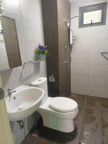 a bathroom with a white toilet and a sink at Meritus in Perai