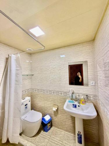 a bathroom with a sink and a toilet at Yusuf Gold House in Samarkand