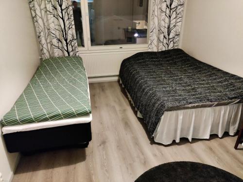 a bedroom with a bed and a window at Loft Ketunleipä - Free Wifi in Tampere