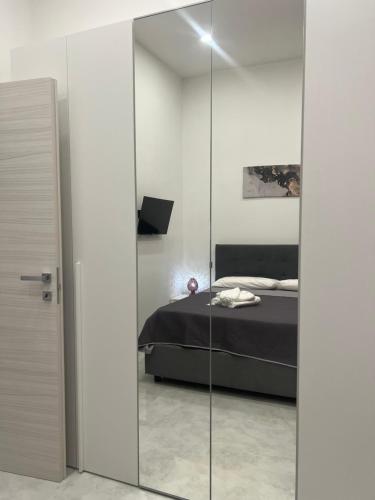 a bedroom with a bed through a glass door at Palazzo Oberdan in Afragola
