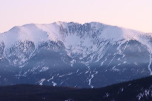 a snow covered mountain in the distance with at Chalet vue imprenable sur lac et pistes in Les Angles
