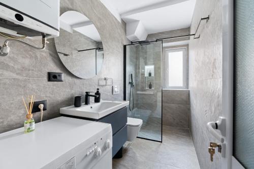 a bathroom with a sink and a toilet and a shower at Katerina's Apartment in Berat
