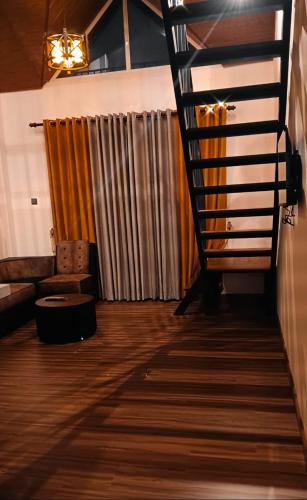 a living room with a staircase and a couch at The Blues Chalet in Nuwara Eliya