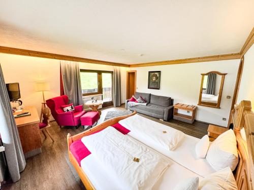 a bedroom with a bed and a living room at Landgasthof Jostalstüble in Titisee-Neustadt