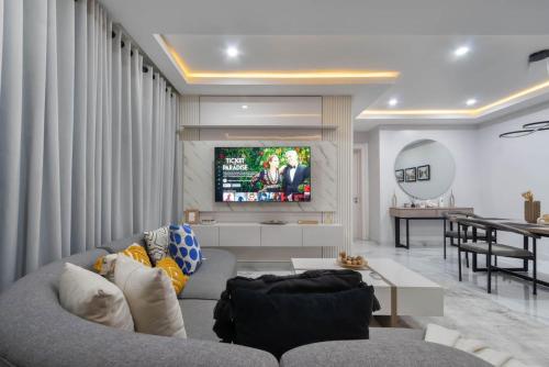 a living room with a couch and a tv at Lekki lagos in Mama