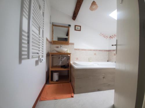 a bathroom with a sink and a bath tub at Gîte La Marteille in Saint-Privat-des-Prés