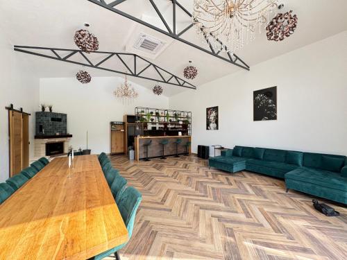 a living room with green couches and a wooden table at Cabana Friends in Valea Inzelului