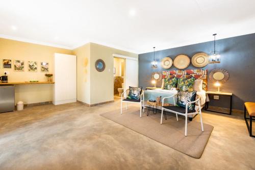 a living room with a table and two chairs at Zabini Lodge and Game Drives in Nelspruit