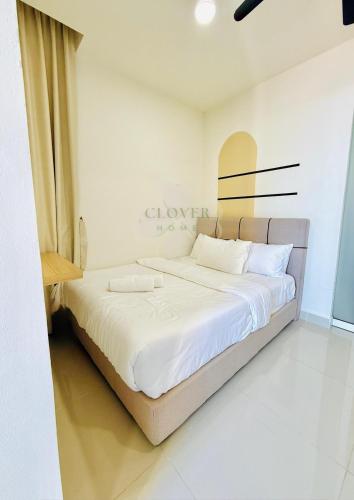 a bedroom with a large bed with white sheets at The Shore Studio Balcony Seaview by Clover Home A13A02 in Kota Kinabalu