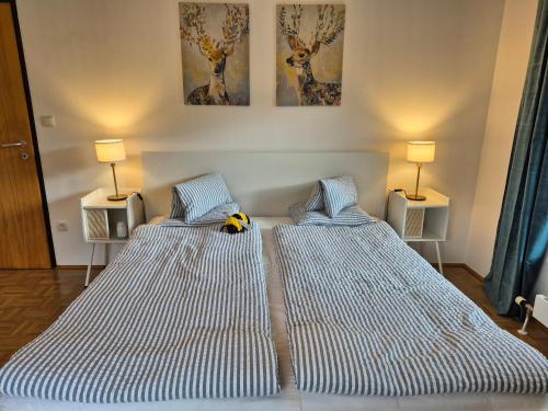 two beds sitting next to each other in a bedroom at appartement bumblebee in Sankt Lambrecht