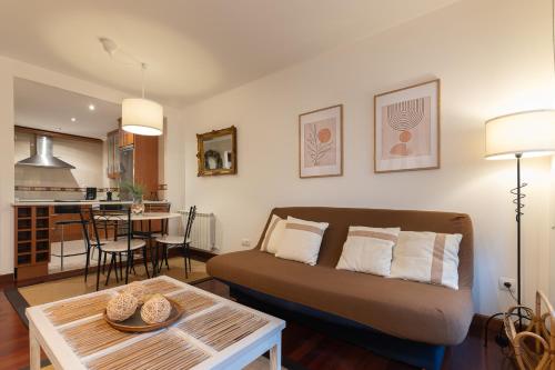 a living room with a couch and a table at La Campanilla de Cabárceno in Sarón