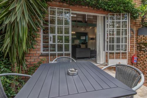 a black table and chairs on a patio at Sitatunga Guest Lodge in Johannesburg