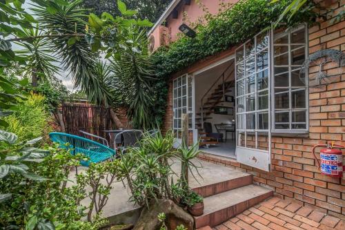 a brick house with a staircase leading to a door at Sitatunga Guest Lodge in Johannesburg