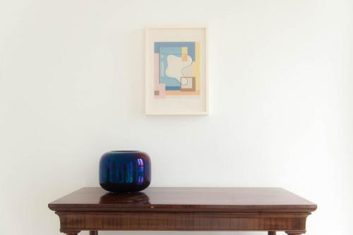 a blue vase sitting on top of a wooden table at Villa Belvedere by Comorooms in Como