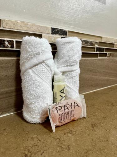 a pair of white socks and a bag of soap at Hôtel Le Roy in Christ Church