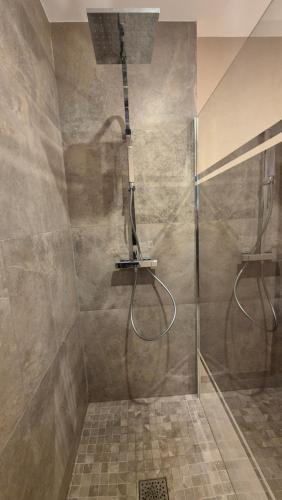 a shower with a shower head in a bathroom at Villa GiGa Algajola in Algajola