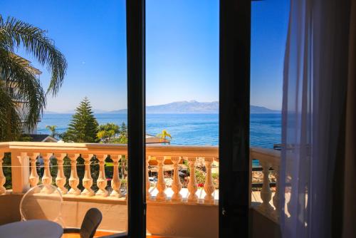 a view of the ocean from a balcony at Hotel Apollon Sarande in Sarandë