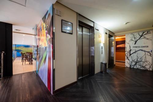 a hallway with a colorful painting on the wall at ibis Styles Belem Nazare in Belém