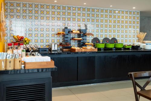 a kitchen with a counter with food on it at ibis Styles Belem Nazare in Belém