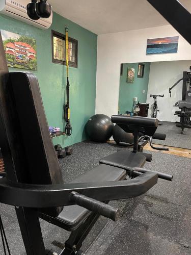 a gym with two exercise bikes in a room at Casa Marbella in Santa Teresa Beach