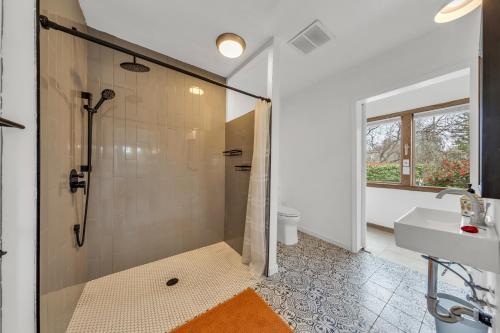 a bathroom with a shower and a sink at Tudors Village BNB in Fair Oaks