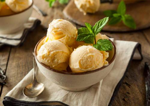 a bowl of ice cream with a sprig of mint at Metro Connected Homestay with Parkview in Greater Noida