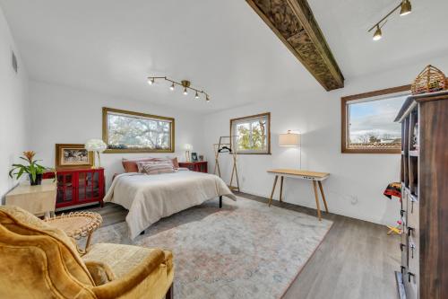 a bedroom with a bed and a couch at Tudors Village BNB in Fair Oaks