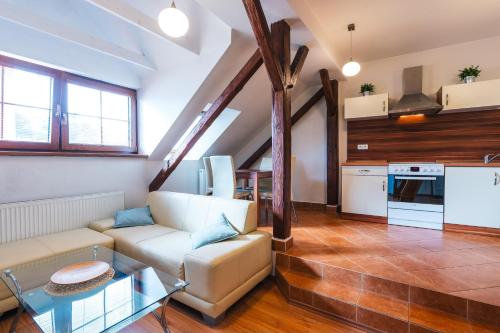 a living room with a couch and a table at Apartmány Elzet in Třeboň