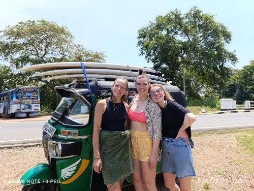 a group of three people standing in front of a vehicle at Surf Dream Villa Arugambay in Arugam Bay