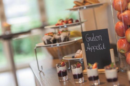 a buffet with desserts and pastries on a table at Best Western Premier Alsterkrug Hotel in Hamburg
