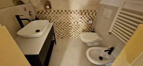 a bathroom with a sink and a toilet at Casa Grotta Francy - Piazza San Giovanni in Matera