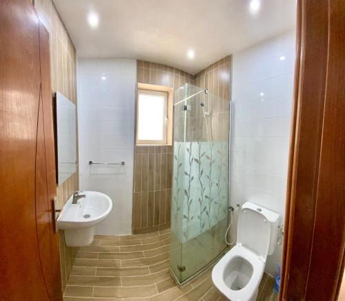 a bathroom with a toilet and a sink at Duplex El mansoura A1 in Kelibia