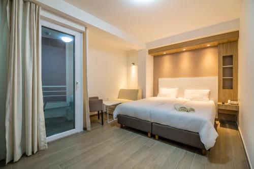 a hotel room with a large bed and a window at Villa Jordan in Ohrid