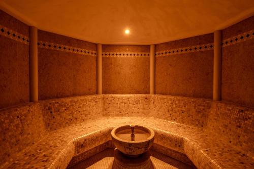 a bath room with a tub in the middle at Paradise Hotel & Wellness in Saint Vincent