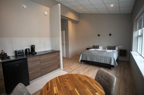 a bedroom with a bed and a table in a room at Skýjaborg Apartments in Höfn