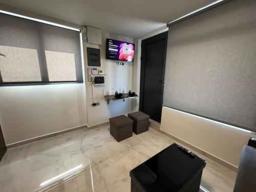 a lobby with a tv and a room with a stool at Rooftop with 360 view in Athens
