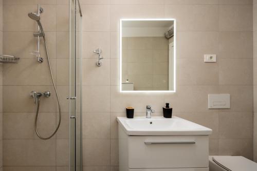 a bathroom with a sink and a shower with a mirror at Split For You - 2BR Apartment with Free Garage Parking in Split