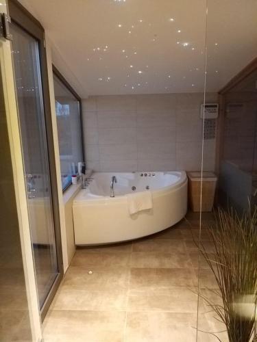 a bathroom with a bath tub in a room at Villa Joy in Nea Makri