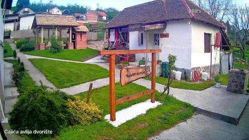a wooden sign in front of a house at Čajića avlija in Obrenovac