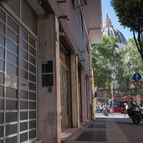 an empty street in a city with a building at Il Perugino Guest House in Rome